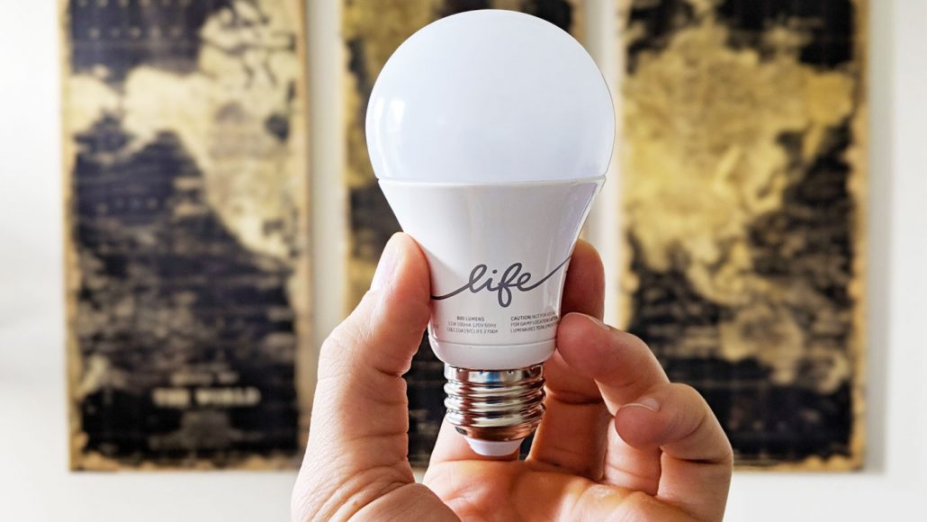Hand holding a C-Life by GE smart bulb